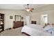 Bright main bedroom with ceiling fan, carpet, large dresser and a view to the ensuite bathroom at 3740 Weather Stone Xing, Zionsville, IN 46077