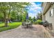 Large backyard patio with dining set, grill, and view of playset, perfect for outdoor living at 3740 Weather Stone Xing, Zionsville, IN 46077