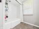This bathroom features a shower over the tub and a window at 3809 N Glenwood Ave, Muncie, IN 47304