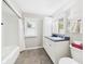 Bright bathroom featuring a tub with shower, tiled floor and large vanity with storage at 3809 N Glenwood Ave, Muncie, IN 47304