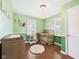 Bright Bedroom featuring a wooden crib, changing table, and playful decorations at 3809 N Glenwood Ave, Muncie, IN 47304
