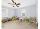 Playroom featuring neutral carpet, a ceiling fan, and two windows at 3809 N Glenwood Ave, Muncie, IN 47304