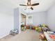 Spacious playroom with neutral carpet, ceiling fan, and organized storage for toys and games at 3809 N Glenwood Ave, Muncie, IN 47304