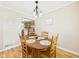 Cozy dining room features a chandelier and wood table, adjacent to the kitchen with oak cabinetry at 3809 N Glenwood Ave, Muncie, IN 47304