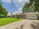 Lovely home featuring an expansive yard and two-car garage with a gravel driveway at 3809 N Glenwood Ave, Muncie, IN 47304