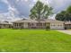 Charming single-story home with a lush green lawn and attached two car garage at 3809 N Glenwood Ave, Muncie, IN 47304