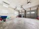 A spacious two-car garage with metal doors and concrete floors at 3809 N Glenwood Ave, Muncie, IN 47304