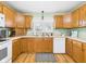A well-organized kitchen with oak cabinets and essential appliances, offering both functionality and style at 3809 N Glenwood Ave, Muncie, IN 47304