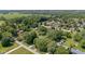 An expansive aerial view displays a neighborhood with tree-lined streets and scattered homes at 396 W 500 S, Anderson, IN 46013