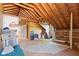 Unfinished attic space with exposed beams, unfinished walls, exposed insulation, and plywood flooring at 396 W 500 S, Anderson, IN 46013