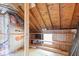 Unfinished attic space with exposed beams, insulation, shelving and plywood flooring at 396 W 500 S, Anderson, IN 46013