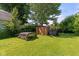 Backyard with shed and trailer, providing ample storage and utility space in a well-maintained outdoor setting at 396 W 500 S, Anderson, IN 46013
