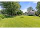 Expansive backyard with a well-maintained lawn and mature trees, offering ample space for outdoor activities and relaxation at 396 W 500 S, Anderson, IN 46013