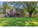 Expansive backyard featuring a well-maintained lawn, mature trees, and a cozy patio with a gazebo, perfect for outdoor relaxation at 396 W 500 S, Anderson, IN 46013