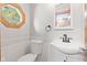 Bathroom featuring a white vanity, toilet, and white brick-look wall at 396 W 500 S, Anderson, IN 46013