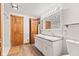Bright bathroom featuring a double sink vanity with wood accents and subway tile walls at 396 W 500 S, Anderson, IN 46013