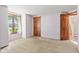Neutral bedroom showcasing an exterior window and doors leading to a closet and stairway at 396 W 500 S, Anderson, IN 46013