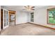 Neutral bedroom showcasing large windows and an open door to the charming living room at 396 W 500 S, Anderson, IN 46013