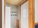 Entryway with a white front door, light walls, gray wood-look paneling, and four hooks at 396 W 500 S, Anderson, IN 46013