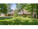 Well-maintained home featuring a brick facade, manicured lawn, and mature trees, offering a welcoming curb appeal at 396 W 500 S, Anderson, IN 46013