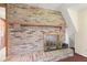 Close-up view of a brick fireplace with glass doors and hearth at 396 W 500 S, Anderson, IN 46013