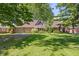 Charming brick home with a well-manicured lawn and mature trees offering shade and curb appeal at 396 W 500 S, Anderson, IN 46013