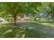 Spacious front yard with mature trees, showcasing the home's setting and curb appeal at 396 W 500 S, Anderson, IN 46013