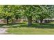 Traditional home featuring a large, well-maintained front yard with mature shade trees at 396 W 500 S, Anderson, IN 46013