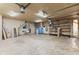 Spacious garage with overhead lighting, shelving, utility sink and workbench at 396 W 500 S, Anderson, IN 46013