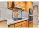 Kitchen featuring a granite island, built in oven, and modern appliances at 396 W 500 S, Anderson, IN 46013