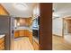 Galley-style kitchen featuring stainless steel appliances, light wood cabinets, and stylish wood flooring at 396 W 500 S, Anderson, IN 46013