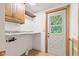 Laundry room with a white door with glass, white walls, and neutral countertop at 396 W 500 S, Anderson, IN 46013