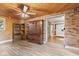 Inviting living room with wood ceiling, exposed brick, built-in shelving, and wood-look vinyl plank flooring at 396 W 500 S, Anderson, IN 46013