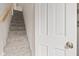 Carpeted stairway with a white door at 396 W 500 S, Anderson, IN 46013