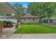 Landscaped backyard with a detached garage, shed, and patio at 4046 N Park Ave, Indianapolis, IN 46205
