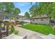 Landscaped backyard featuring a covered patio and a detached garage at 4046 N Park Ave, Indianapolis, IN 46205