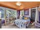 This bedroom boasts playful purple walls, bright accents, three windows, and unique stylish personal touches at 4046 N Park Ave, Indianapolis, IN 46205