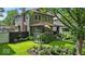 Charming home featuring a well-manicured front yard with colorful flowers and lush greenery at 4046 N Park Ave, Indianapolis, IN 46205