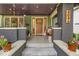 Inviting front porch with brick accents, decorative lighting, and cozy seating area at 4046 N Park Ave, Indianapolis, IN 46205