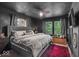 This is a main bedroom with dark walls, a gray bedspread, and two windows letting in natural light at 4046 N Park Ave, Indianapolis, IN 46205