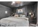 This is a main bedroom with dark walls, a gray bedspread, and two windows letting in natural light at 4046 N Park Ave, Indianapolis, IN 46205