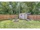 Backyard shed provides extra storage, complemented by a firepit area with chairs, perfect for gatherings at 4431 Cranbrook Dr, Indianapolis, IN 46250