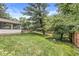 Expansive backyard features a pool with a diving board, a patio with seating, and lush landscaping, ideal for outdoor living at 4431 Cranbrook Dr, Indianapolis, IN 46250