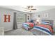 Inviting bedroom with two beds, a ceiling fan, and a neutral color scheme, creating a serene atmosphere at 4431 Cranbrook Dr, Indianapolis, IN 46250