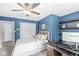 Bedroom featuring a comfortable bed, a ceiling fan, and a built-in workspace for studying or working at 4431 Cranbrook Dr, Indianapolis, IN 46250