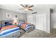 Well-lit bedroom with two comfortable beds, ceiling fan, and ample storage, ideal for Gathering or guests at 4431 Cranbrook Dr, Indianapolis, IN 46250