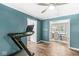 A well-lit exercise room with a treadmill and access to a dining area at 4431 Cranbrook Dr, Indianapolis, IN 46250