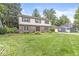 Traditional two-story home with a brick facade, mature landscaping, a well-manicured lawn, and a basketball hoop at 4431 Cranbrook Dr, Indianapolis, IN 46250