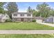 Charming brick and siding home with a well-manicured lawn and beautiful landscaping at 4431 Cranbrook Dr, Indianapolis, IN 46250