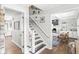 Hallway with staircase leading to the kitchen and living room with white built-in shelving at 4431 Cranbrook Dr, Indianapolis, IN 46250